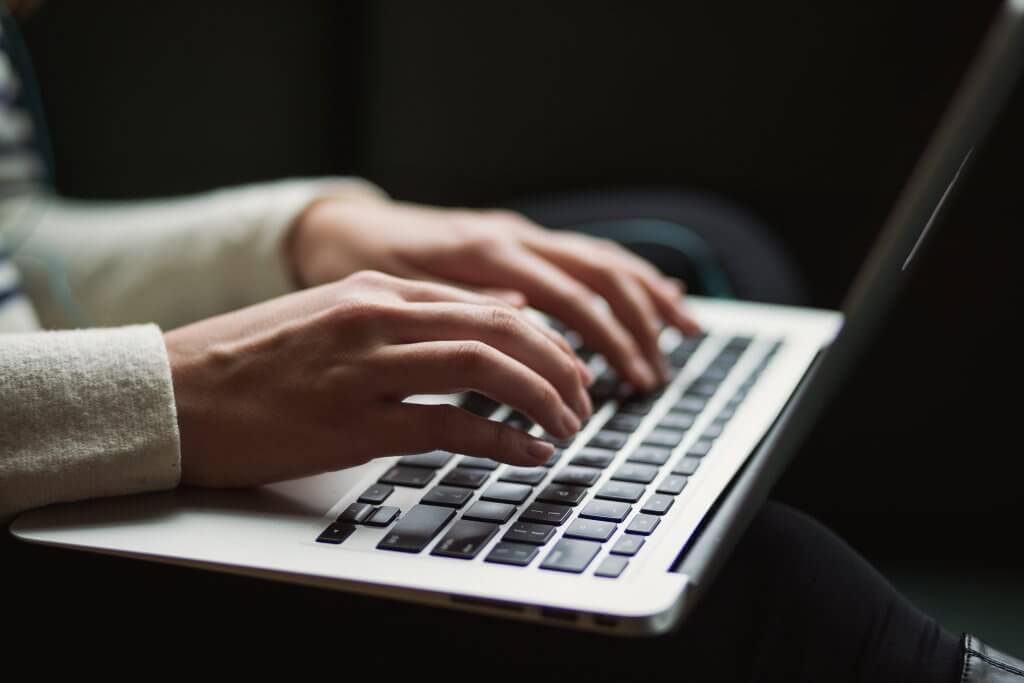 woman typing on laptop