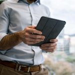 man looking at business accounts on iPad