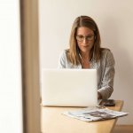 Woman working on a laptop looking up why she should hire an accounting firm