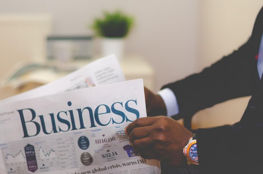 Man reading small business paper