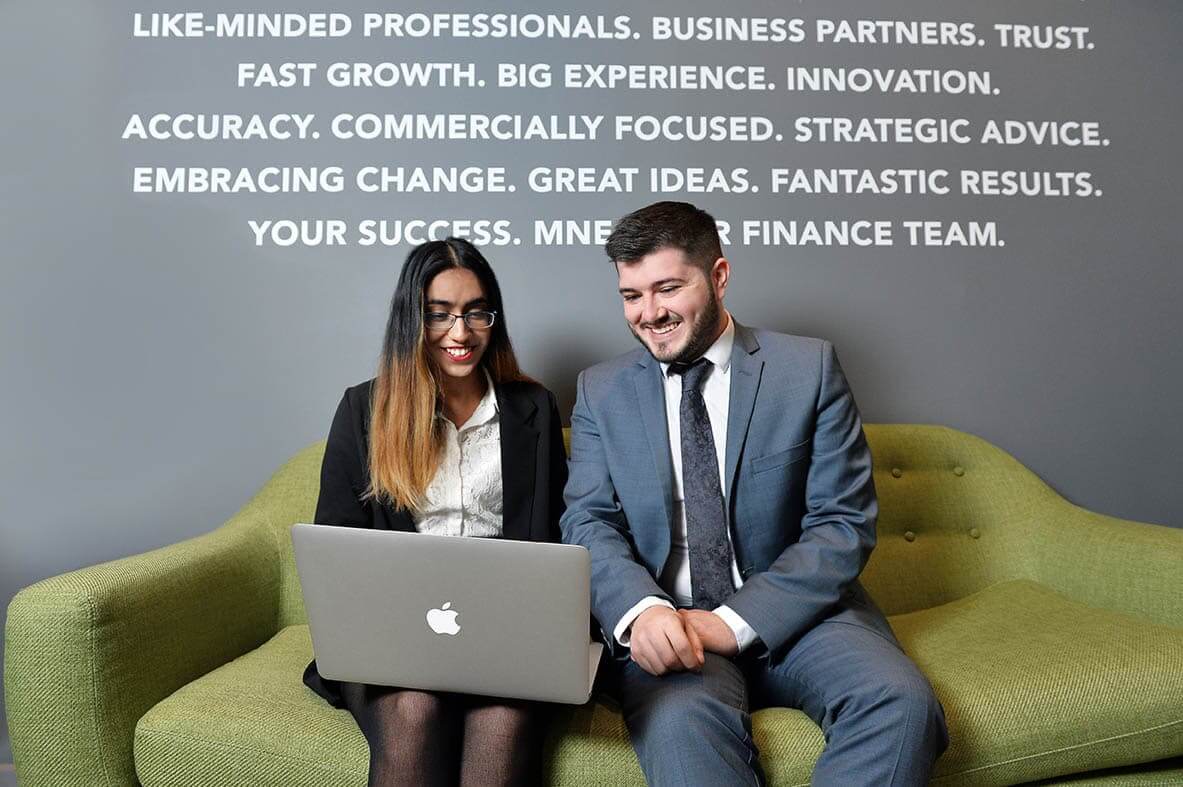 2 young accountants sitting in the office of our accounting firm